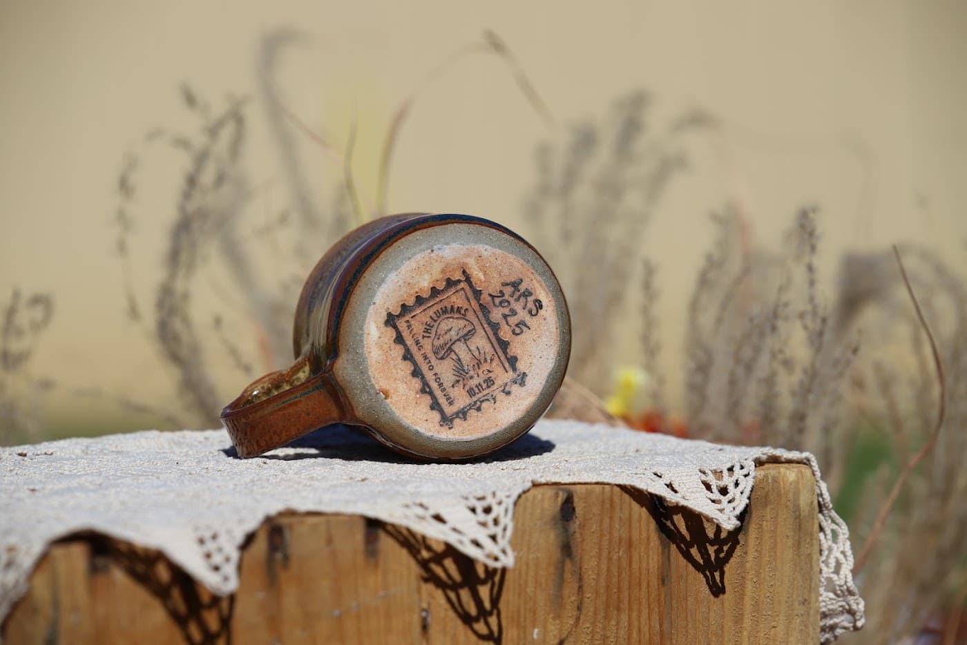 Wedding favor mug tipped on its side revealing the stamped makers mark