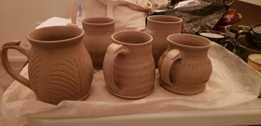 Hand-carved greenware mugs with fern and dash textures